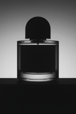 Minimalist Byredo perfume bottle photographed in black and white, contemporary photography with experimental visual art style by IMPROMPTU Studio.