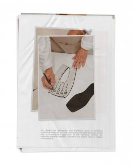 Hands working on a shoe pattern design on paper, photographed in a minimalist setting by IMPROMPTU Studio, showcasing contemporary photography and experimental visual art. 